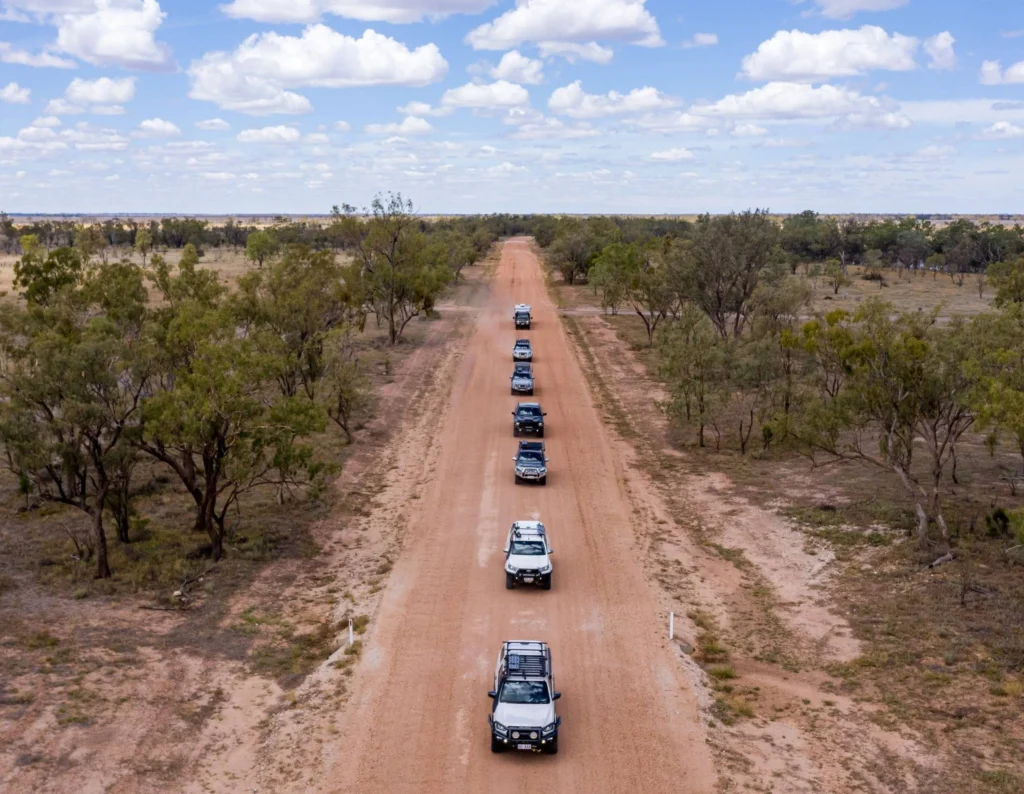 Convoy of TJM vehicles on a dirt road