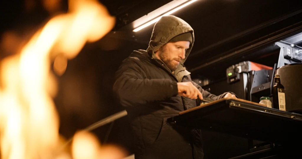 Philip Thurston cooking dinner at camp