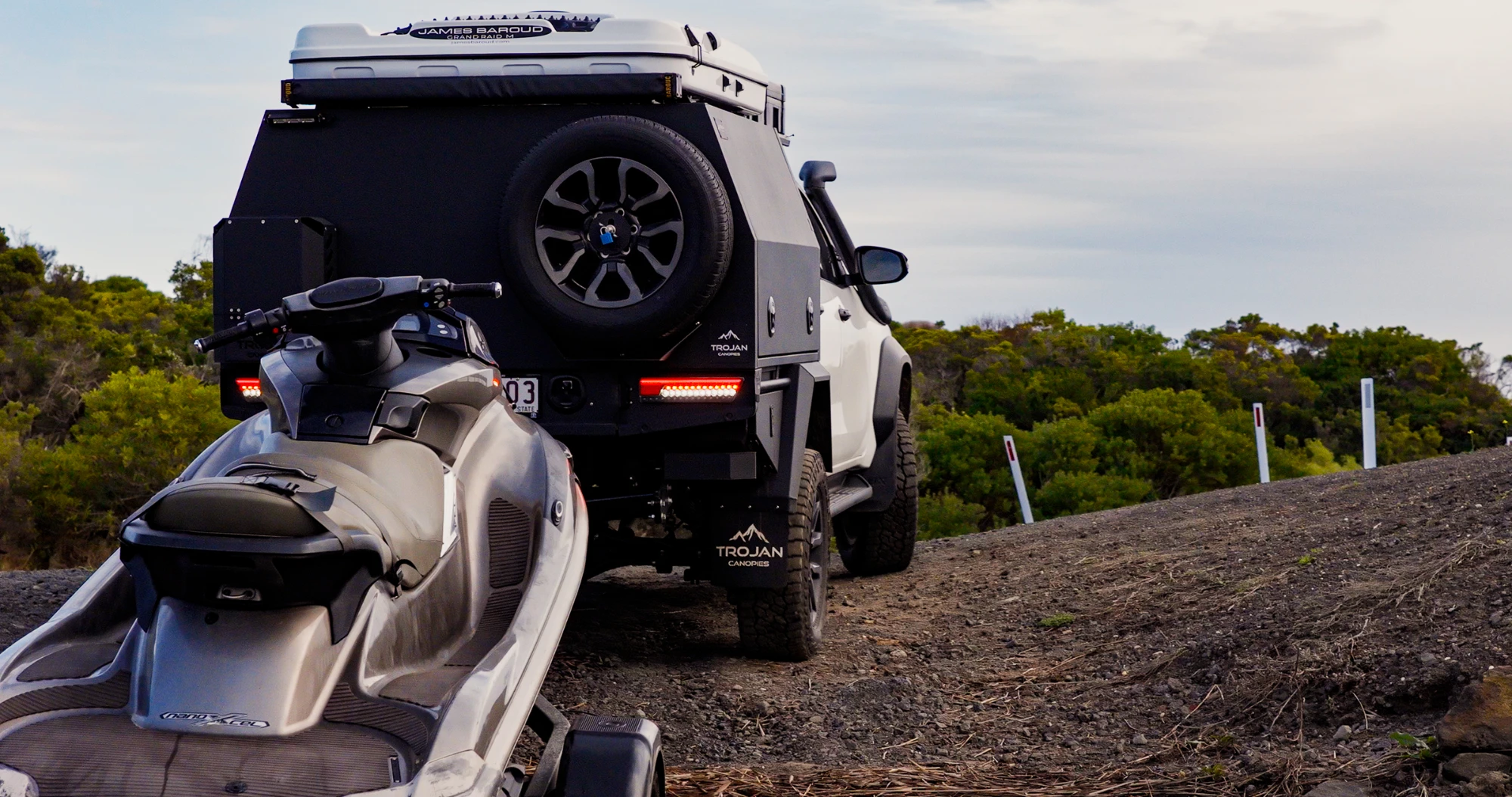 White Hilux with Trojan Canopy towing jet ski